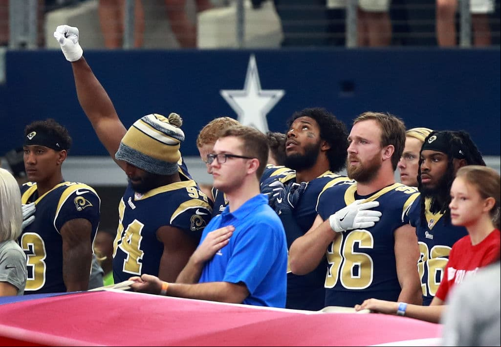 ARLINGTON, TX - OCTOBER 01: Robert Quinn #94 of the Los Angeles Rams raises his fist during the National Anthem before the game against the Dallas Cowboys at AT&T Stadium on October 1, 2017 in Arlington, Texas. (Photo by Tom Pennington/Getty Images)
